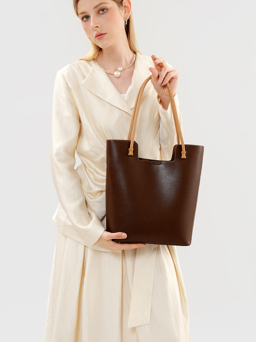 The Liora Leather Tote in Tea Brown — styled view